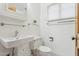 Bathroom featuring a pedestal sink, toilet, and a glass shelf for storage at 1129 W Holly St, Phoenix, AZ 85007