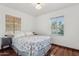 Bright bedroom with hardwood floors, neutral walls, and two windows that bring in plenty of natural light at 1129 W Holly St, Phoenix, AZ 85007