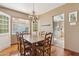 Elegant dining room with a chandelier and a view into the kitchen, ideal for Gathering meals at 1129 W Holly St, Phoenix, AZ 85007