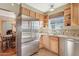 Bright kitchen with stainless steel refrigerator, granite counters, and wood cabinetry near the dining area at 1129 W Holly St, Phoenix, AZ 85007