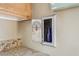 A small storage space in a kitchen featuring granite countertops and stained wood cabinets at 1129 W Holly St, Phoenix, AZ 85007