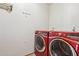 Laundry room showcasing a modern red washer and dryer set with a clean, functional space at 1129 W Holly St, Phoenix, AZ 85007