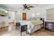 This main bedroom features tile floors, ceiling fan, king bed, and a sliding barn door to the bathroom at 1129 W Holly St, Phoenix, AZ 85007