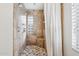 The shower features decorative tile, a glass block window, and multiple shower heads at 1129 W Holly St, Phoenix, AZ 85007