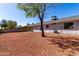 Landscaped backyard featuring gravel, a mature tree, and a partial view of the home's exterior at 11451 S Half Moon Dr, Phoenix, AZ 85044