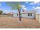 Spacious backyard with desert landscaping, offering a blank canvas for customization at 11451 S Half Moon Dr, Phoenix, AZ 85044