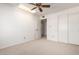 Bedroom featuring neutral carpet, ceiling fan, and closet at 11451 S Half Moon Dr, Phoenix, AZ 85044