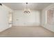 Bright dining room with a chandelier and view into the adjacent living spaces at 11451 S Half Moon Dr, Phoenix, AZ 85044