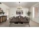 Elegant dining room featuring a modern chandelier, ample seating, and a large window for plenty of natural light at 11451 S Half Moon Dr, Phoenix, AZ 85044