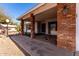 Charming covered front porch with brick pillars, desert landscaping, and a view of the home's architecture at 11451 S Half Moon Dr, Phoenix, AZ 85044