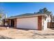 Two-car garage with brick accents, integrated into the home's design, next to desert landscaping in Arizona at 11451 S Half Moon Dr, Phoenix, AZ 85044