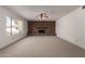 Bright living room featuring a brick fireplace and a ceiling fan at 11451 S Half Moon Dr, Phoenix, AZ 85044