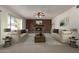 Inviting living room with a brick fireplace, neutral color palette, and large windows that fill the space with natural light at 11451 S Half Moon Dr, Phoenix, AZ 85044