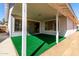 A covered patio with bright green turf transitions to a gravel backyard bordered by a block wall for privacy at 11451 S Half Moon Dr, Phoenix, AZ 85044