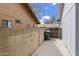 Side yard features a concrete walkway and secure fencing, ideal for storage at 11451 S Half Moon Dr, Phoenix, AZ 85044