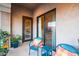 Balcony furnished with a table and chairs, with colorful potted plants and sliding glass doors at 11640 N Tatum Blvd # 3074, Phoenix, AZ 85028