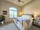Bright bedroom with a large window, ceiling fan, and decorative furnishings at 11640 N Tatum Blvd # 3074, Phoenix, AZ 85028