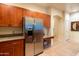 Kitchen with stainless steel refrigerator and custom wood cabinets at 11640 N Tatum Blvd # 3074, Phoenix, AZ 85028