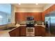 Well-equipped kitchen features stainless steel appliances, wooden cabinets, and beautiful granite countertops at 11640 N Tatum Blvd # 3074, Phoenix, AZ 85028