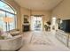 Expansive living room with fireplace, large windows, access to patio, and ample seating at 11640 N Tatum Blvd # 3074, Phoenix, AZ 85028
