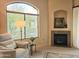 Bright living room with large windows, fireplace, and comfortable seating area at 11640 N Tatum Blvd # 3074, Phoenix, AZ 85028