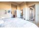 Bedroom featuring an en-suite bathroom, balcony, and serene decor at 11640 N Tatum Blvd # 3074, Phoenix, AZ 85028