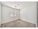 Bedroom featuring neutral carpet, window with blinds, and ample natural light at 11765 W Maui Ln, El Mirage, AZ 85335