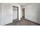 Bedroom featuring carpet, closet, and access to the hallway at 11765 W Maui Ln, El Mirage, AZ 85335