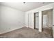 Bedroom view showcasing a sliding door closet and access to the hallway at 11765 W Maui Ln, El Mirage, AZ 85335