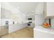 Bright kitchen with white cabinetry, quartz countertops, and stainless steel appliances at 11765 W Maui Ln, El Mirage, AZ 85335