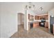 Kitchen featuring wood cabinets, tile countertops, black appliances, tile flooring, and eat-in dining at 11765 W Maui Ln, El Mirage, AZ 85335