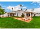 Landscaped backyard featuring a grassy lawn and an expansive patio at 120 E Calavar Rd, Phoenix, AZ 85022