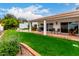 Backyard featuring a well-manicured lawn and a covered patio area at 120 E Calavar Rd, Phoenix, AZ 85022