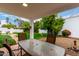 Backyard with table and chairs on a covered patio, perfect for outdoor dining at 120 E Calavar Rd, Phoenix, AZ 85022