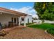 Backyard with lush landscaping, manicured lawn, and patio area at 120 E Calavar Rd, Phoenix, AZ 85022