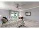 Bright bedroom features a ceiling fan, desk, and sliding glass door with a view of the yard at 120 E Calavar Rd, Phoenix, AZ 85022