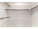 Bright walk-in closet features ample storage space with shelves and rods at 120 E Calavar Rd, Phoenix, AZ 85022