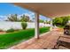 Covered patio with an outdoor view to a well-maintained backyard and lush landscaping at 120 E Calavar Rd, Phoenix, AZ 85022