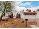 Charming home showcasing terra cotta roof, decorative iron gate, and a well-manicured, low-maintenance yard at 120 E Calavar Rd, Phoenix, AZ 85022