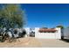 Inviting single-story home featuring a red tile roof and wrought iron accents, complete with a two-car garage at 120 E Calavar Rd, Phoenix, AZ 85022