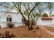 Charming home showcasing terra cotta roof, decorative iron gate, and a well-manicured, low-maintenance yard at 120 E Calavar Rd, Phoenix, AZ 85022