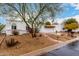 Charming home showcasing terra cotta roof, decorative iron gate, and a well-manicured, low-maintenance yard at 120 E Calavar Rd, Phoenix, AZ 85022