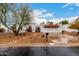 Charming home showcasing terra cotta roof, decorative iron gate, and a well-manicured, low-maintenance yard at 120 E Calavar Rd, Phoenix, AZ 85022