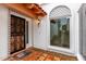 Elegant entryway with ornate iron door, tile accents, arched window, and a welcoming ambiance at 120 E Calavar Rd, Phoenix, AZ 85022