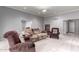 Cozy living room featuring neutral color palette, carpet, ceiling fan, and comfortable seating at 120 E Calavar Rd, Phoenix, AZ 85022