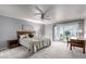 Main bedroom with a large window, gray walls, and a ceiling fan at 120 E Calavar Rd, Phoenix, AZ 85022