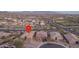 An aerial view of the house nestled in a neighborhood with desert landscaping and mountain views in the background at 12231 S 185Th Ave, Goodyear, AZ 85338