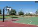 Community basketball court featuring multiple hoops, surrounded by trees and green space at 12231 S 185Th Ave, Goodyear, AZ 85338