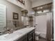 Bathroom featuring a modern vanity, decorative mirror, shower-tub combo, and stylish tile accents at 12231 S 185Th Ave, Goodyear, AZ 85338