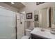 Modern bathroom featuring a glass shower stall, white vanity and sink and light neutral walls and flooring at 12231 S 185Th Ave, Goodyear, AZ 85338